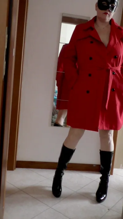Mature chick in high boots and red coat poses seductively for homemade video