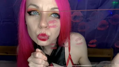 AmilyRose69's lips painted with red lipstick while she kisses in front of the camera