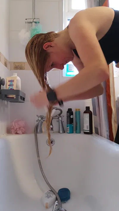 British MILF Clarissa gets her blonde hair wet and dry in POV hair washing video